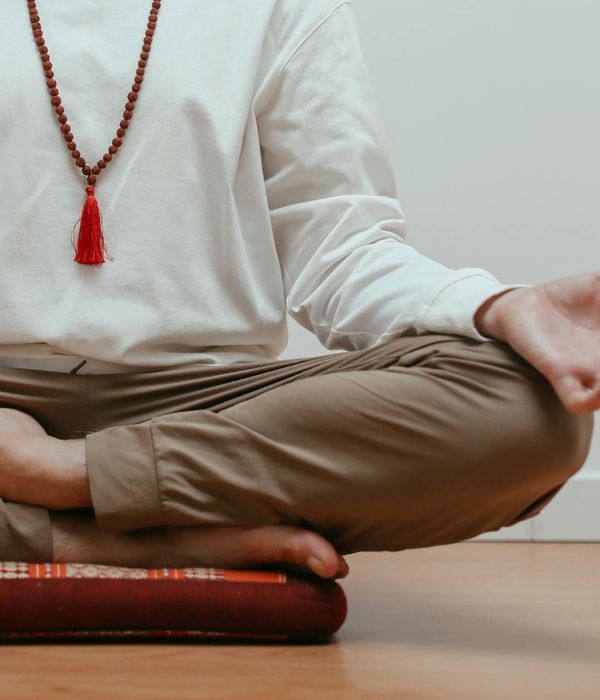 Detailed view of a person's hands in a specific yoga mudra.